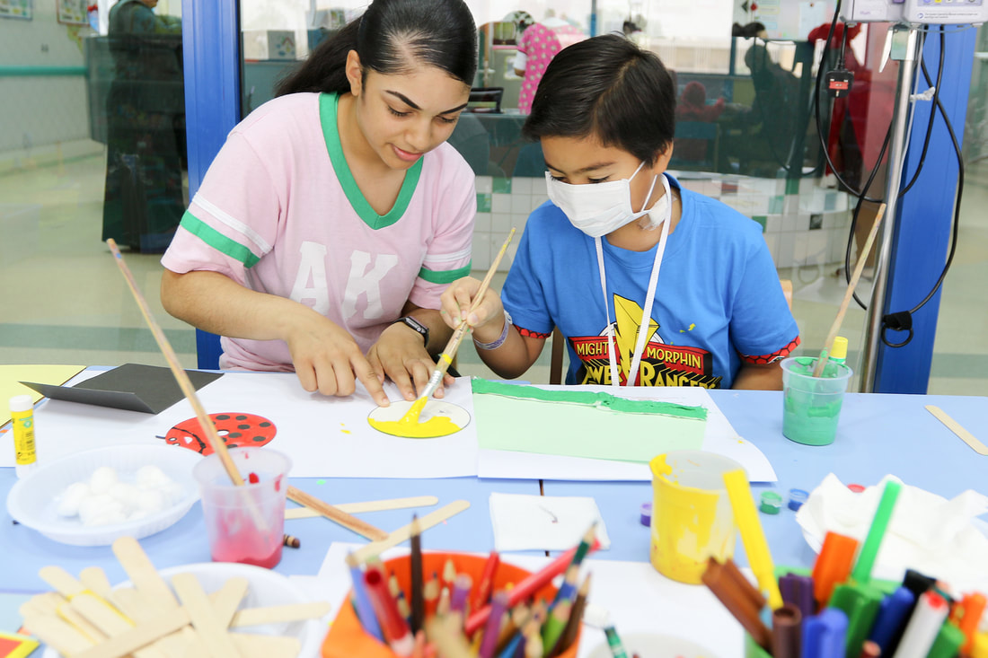 Middle school students learning art with safety masks