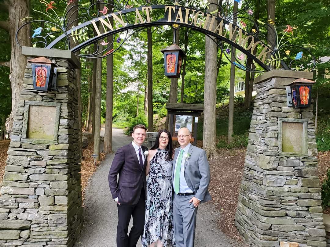 Picture of family in front of a sign. 