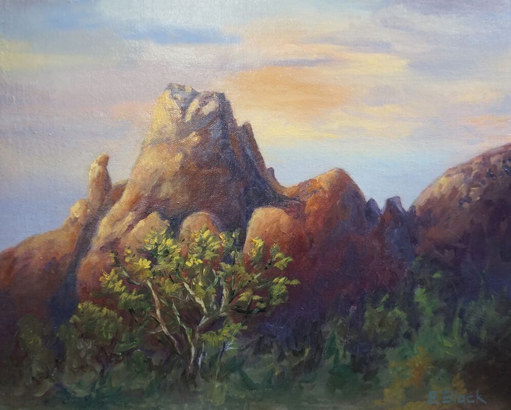A painting of a mountain in at sunset with browns and blues.  