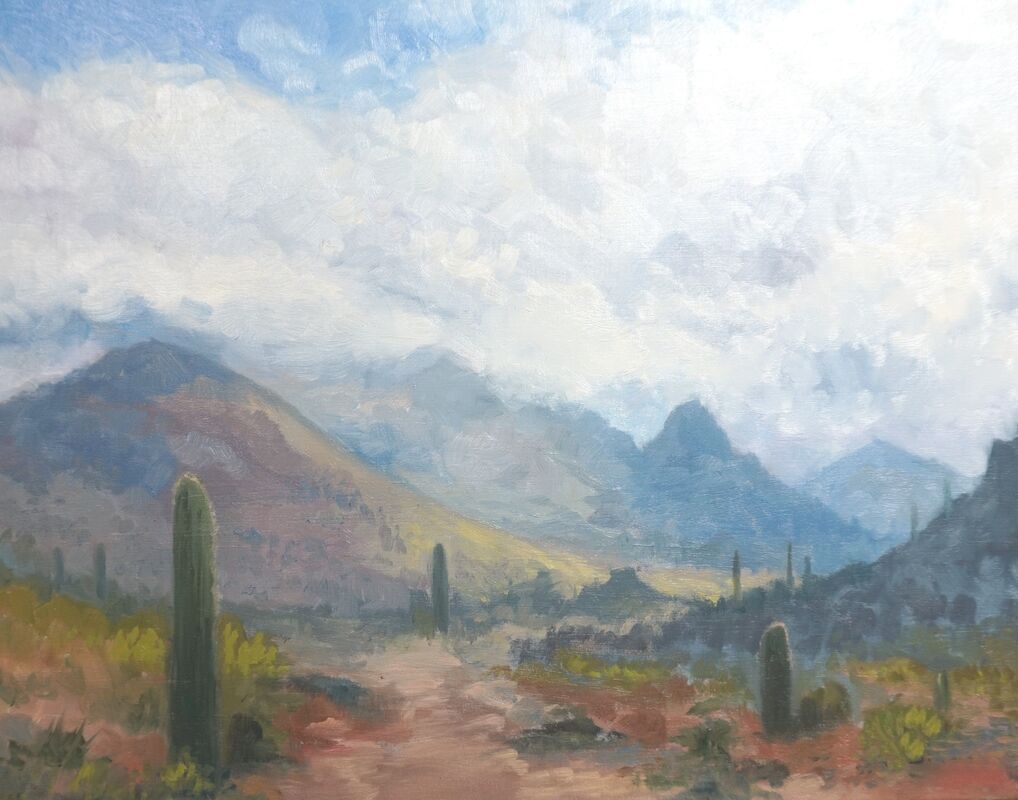 Painting of desert mountains and rain clouds.